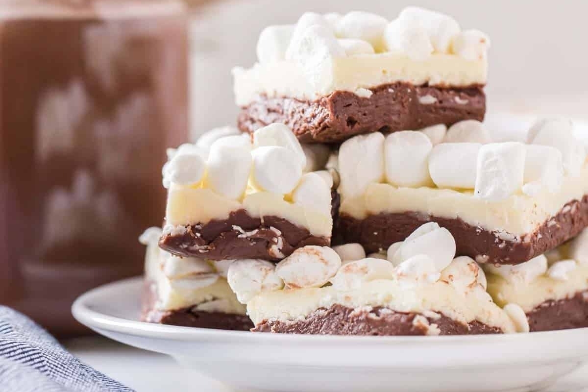 A stack of Christmas chocolate marshmallow bars on a plate.