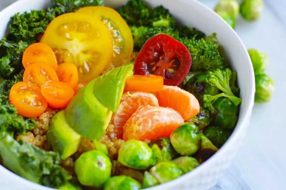 A grain bowl filled with fruits and vegetables.