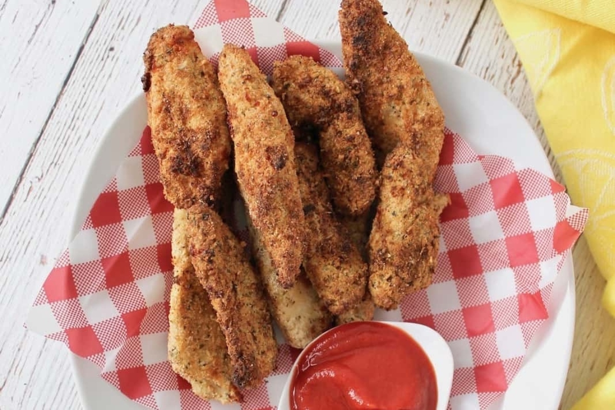Easiest Game Day Recipe: Chicken fingers on a plate with ketchup.