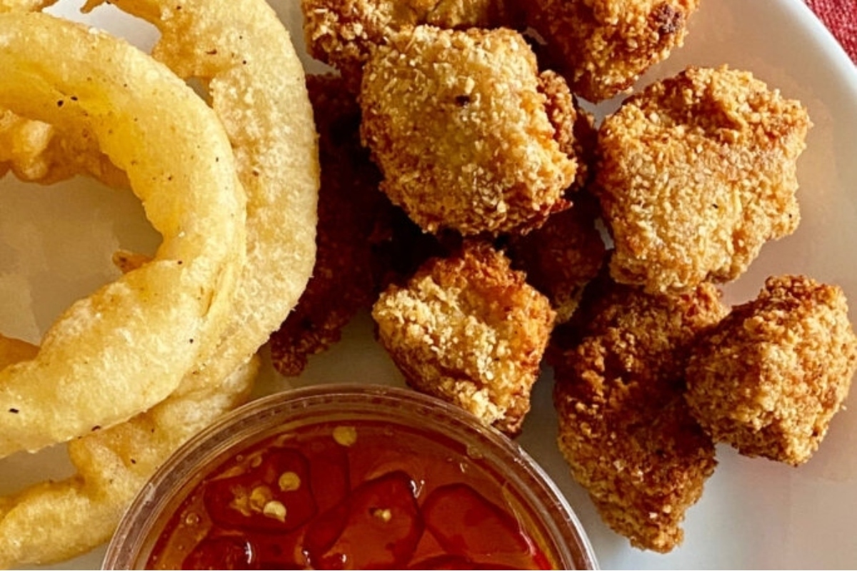 Low Carb chicken nuggets and onion rings on a plate.