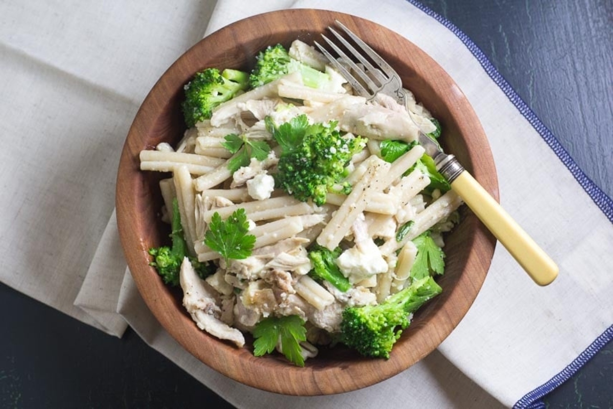 Delicious chicken and broccoli pasta recipe served in a stylish wooden bowl.