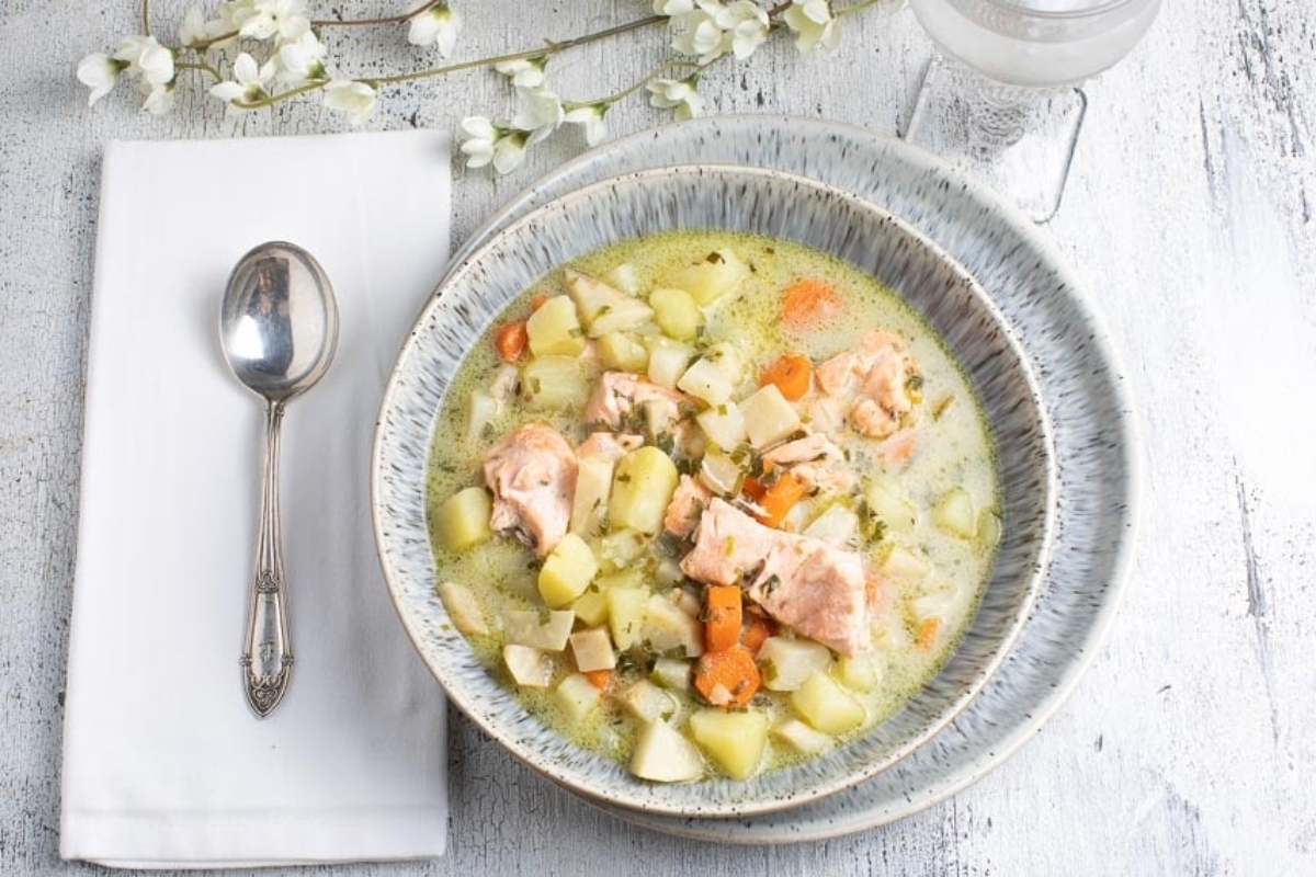 A salmon chowder with potatoes and carrots.
