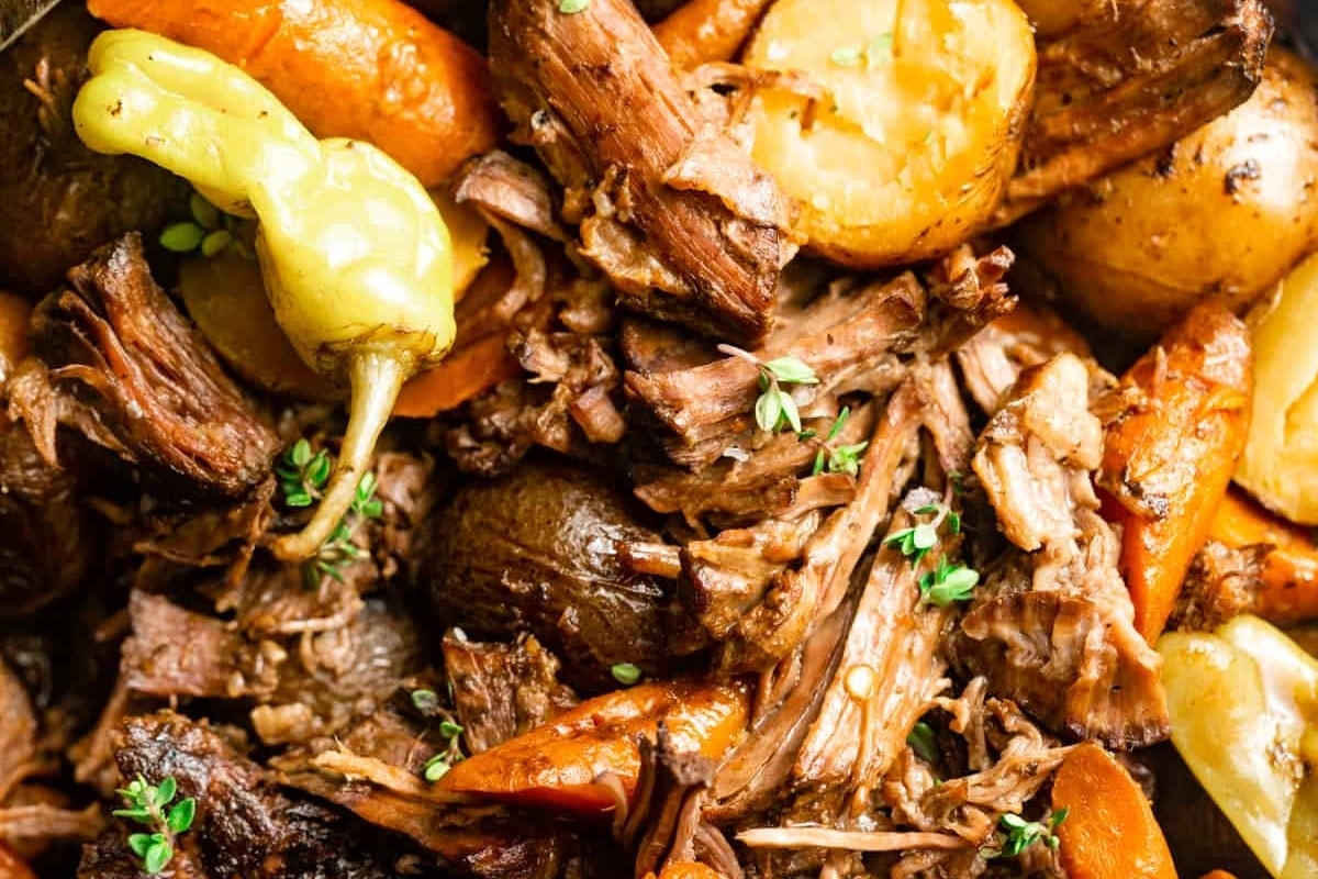Slow cooker pulled pork with carrots and potatoes. Perfect for Christmas dinners.
