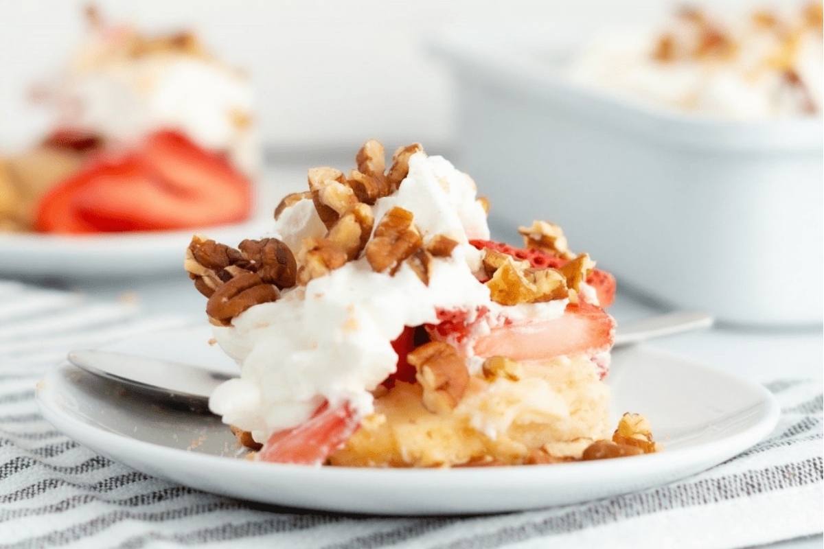 A delightful dessert plate filled with luscious strawberries and a dollop of fluffy whipped cream.