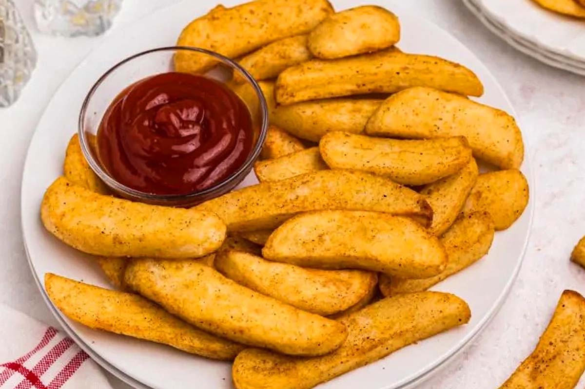 French fries with ketchup on a plate, perfect for anyone looking for Fry Recipes.