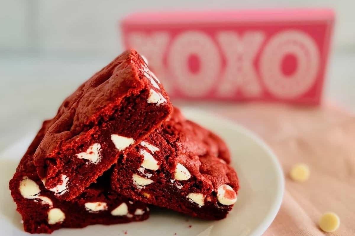 A plate of red velvet brownies, perfect for Valentine's Day, on a white plate.