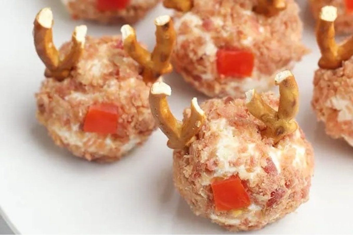 Reindeer meatballs with festive pretzels on a plate.