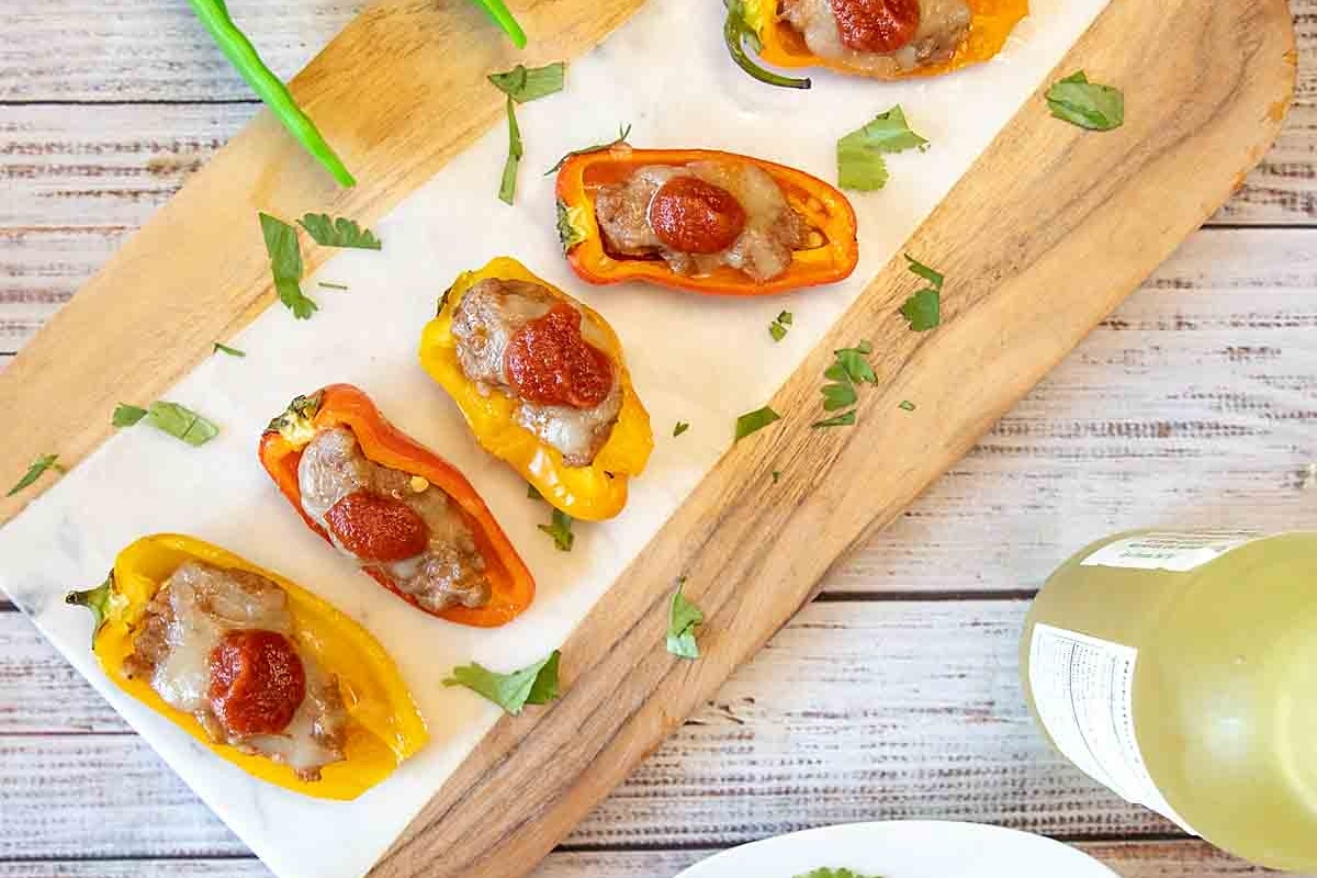 48 Easy Bite-Sized Appetizers Party Guests Will Love 34 Bite-sized stuffed peppers on a cutting board.