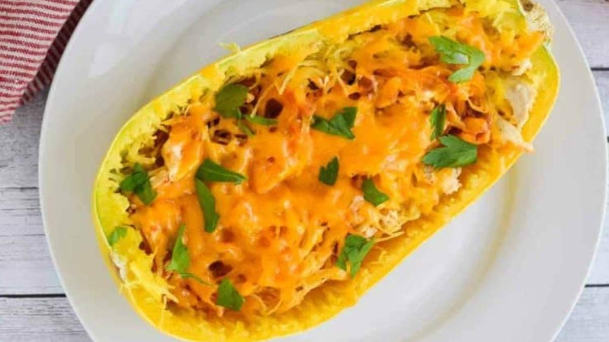 Cheesy squash boats on a white plate.