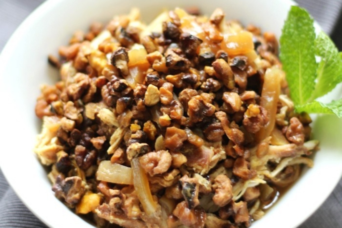 A bowl of black eyed peas with mint leaves.