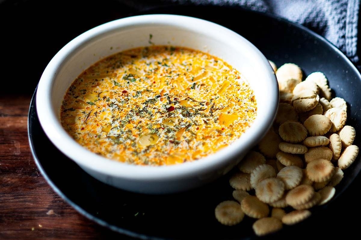 A simple and elegant bowl of dip with crackers, perfect for a New Year's Eve celebration.