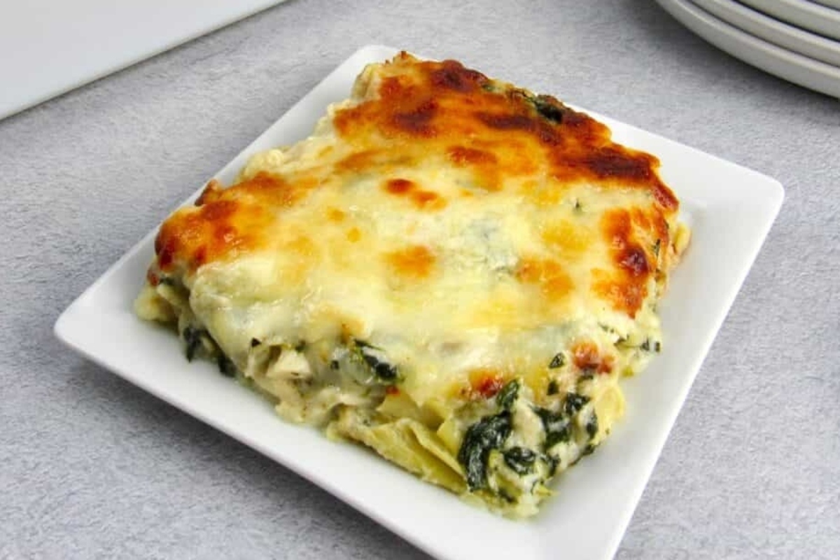Low-carb spinach lasagna on a white plate.