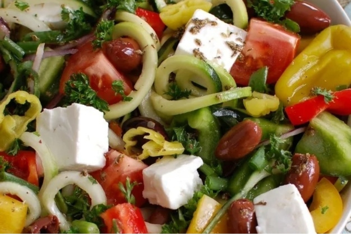 Spiralized Greek salad with cucumbers, tomatoes and feta cheese.