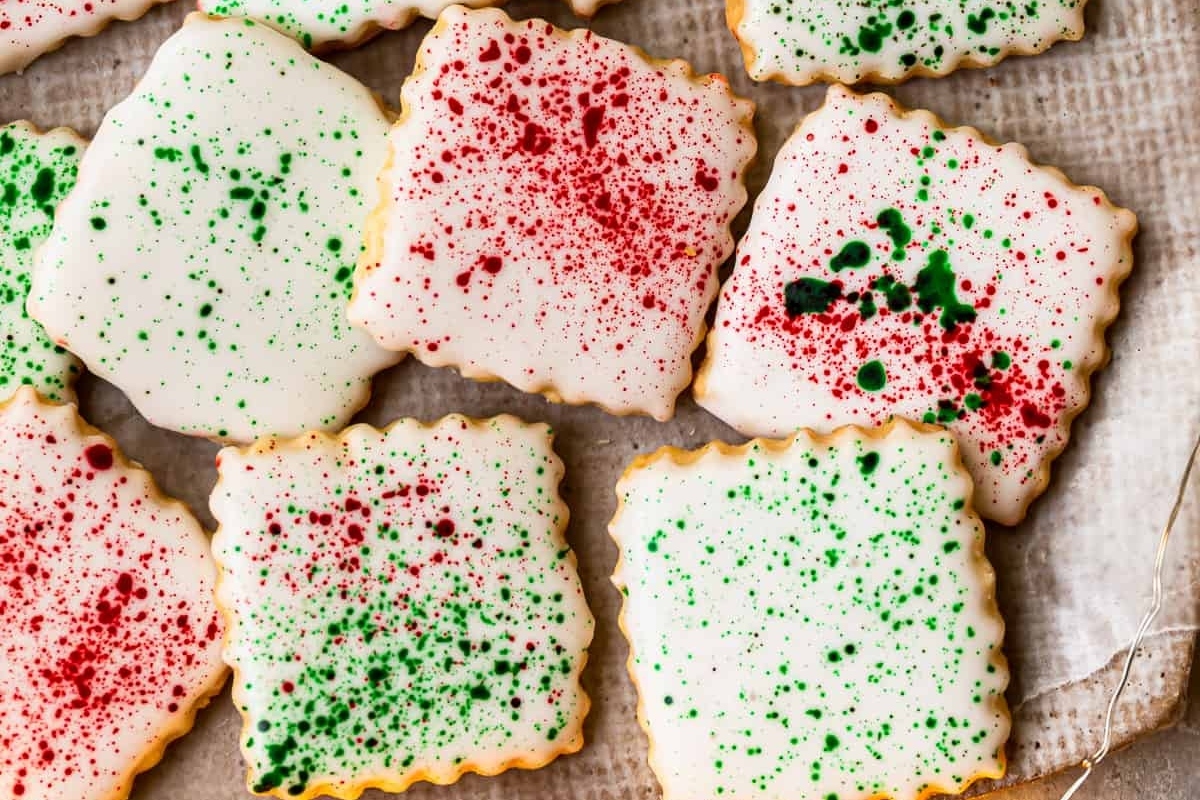 Christmas cookies with sprinkles on a piece of parchment paper.
