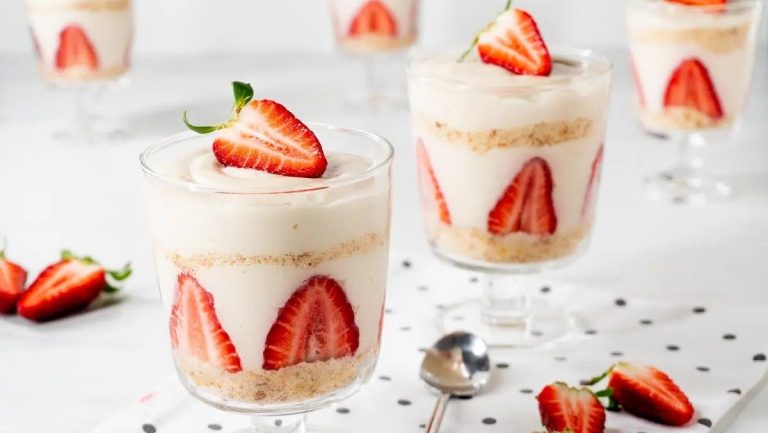 A trio of Valentine's Day desserts in glasses on a polka dot tablecloth.