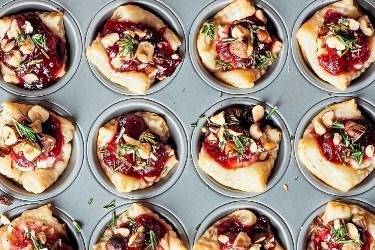 Cheesy cranberry almond tarts in a muffin tin perfect for appetizers during Christmas.