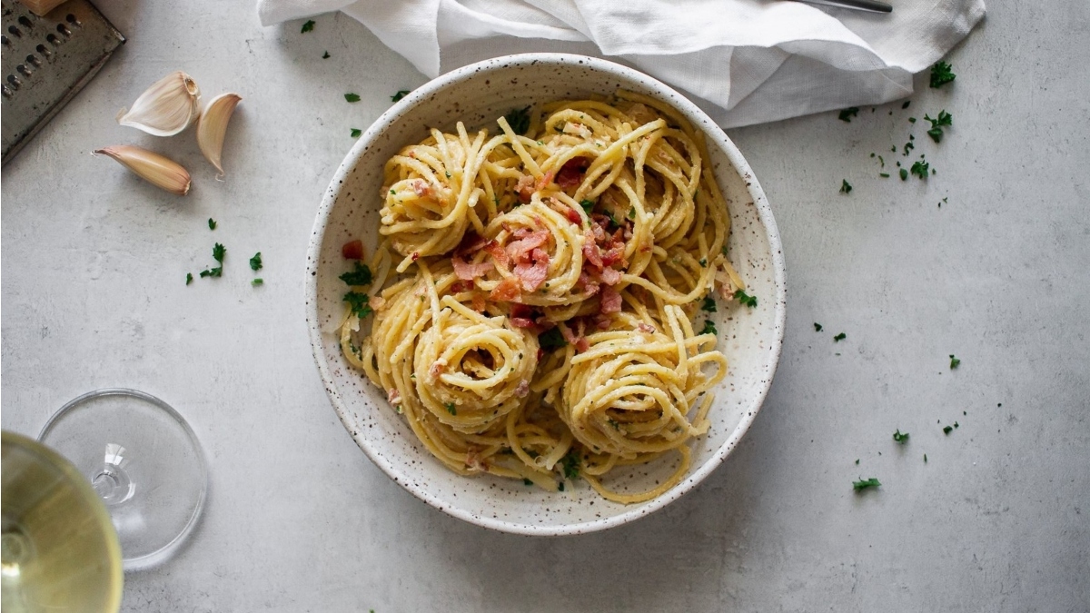 A romantic Valentine's Day main dish, featuring a delicious bowl of spaghetti topped with savory garlic and sprinkled with flavorful parmesan cheese.