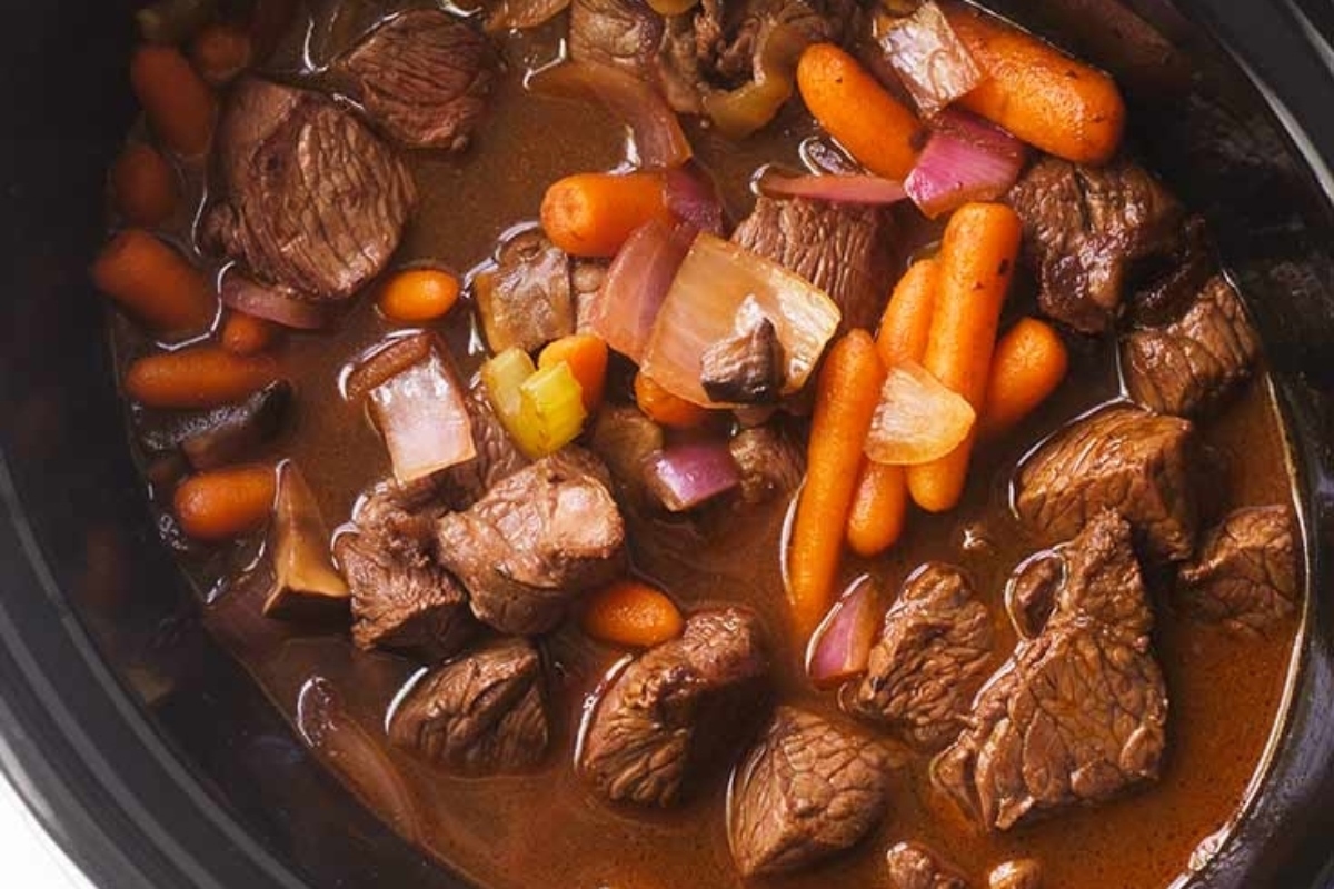 Slow cooker beef stew with carrots and onions.