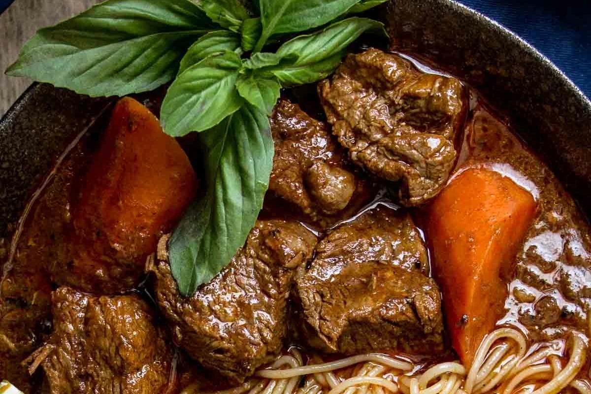A hearty winter recipe for beef stew with comforting noodles and fragrant basil.