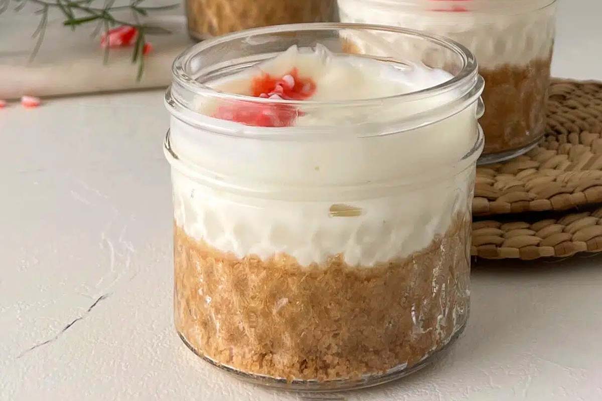 Two mason jars filled with whipped cream, perfect for indulging in delectable candy cane recipes.