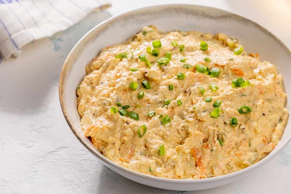 A creamy dip with carrots and green onions.
