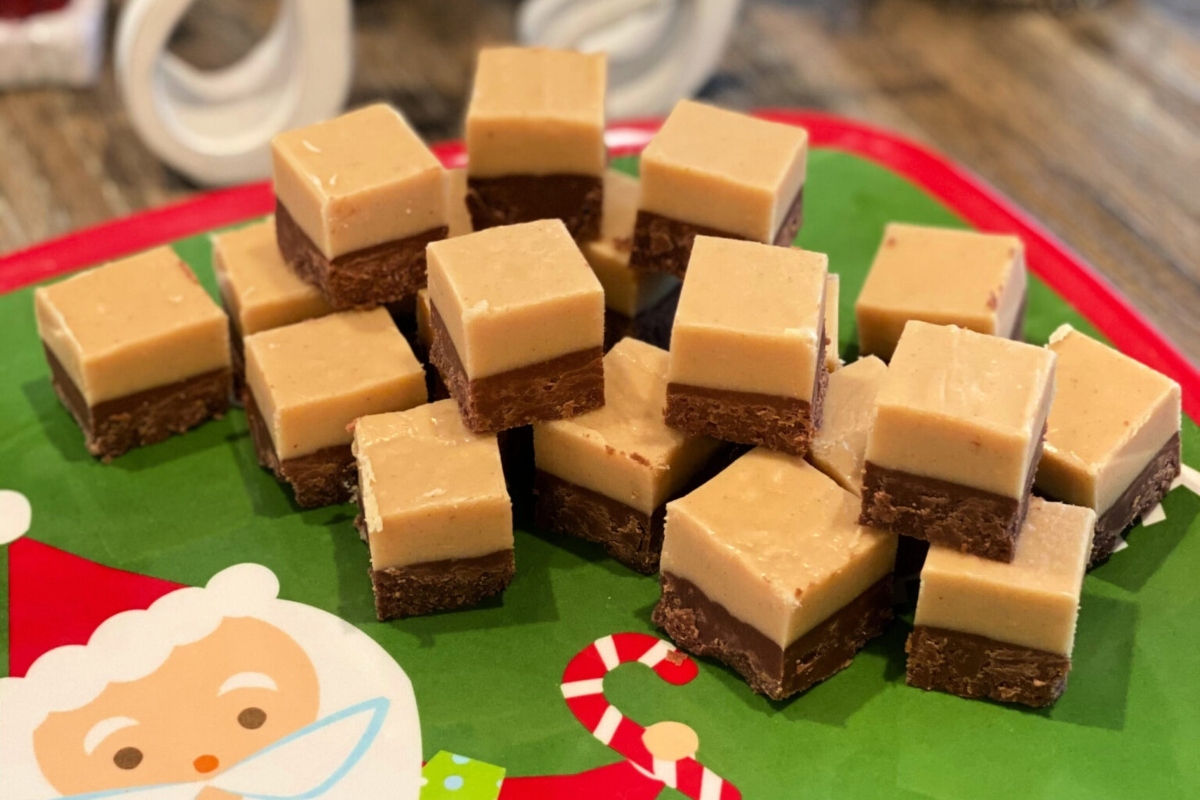 Christmas peanut butter fudge squares on a green plate.