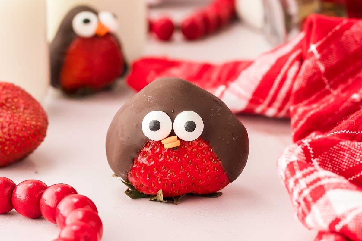 A group of chocolate strawberries with owls on them, perfect for festive Christmas candy recipes.