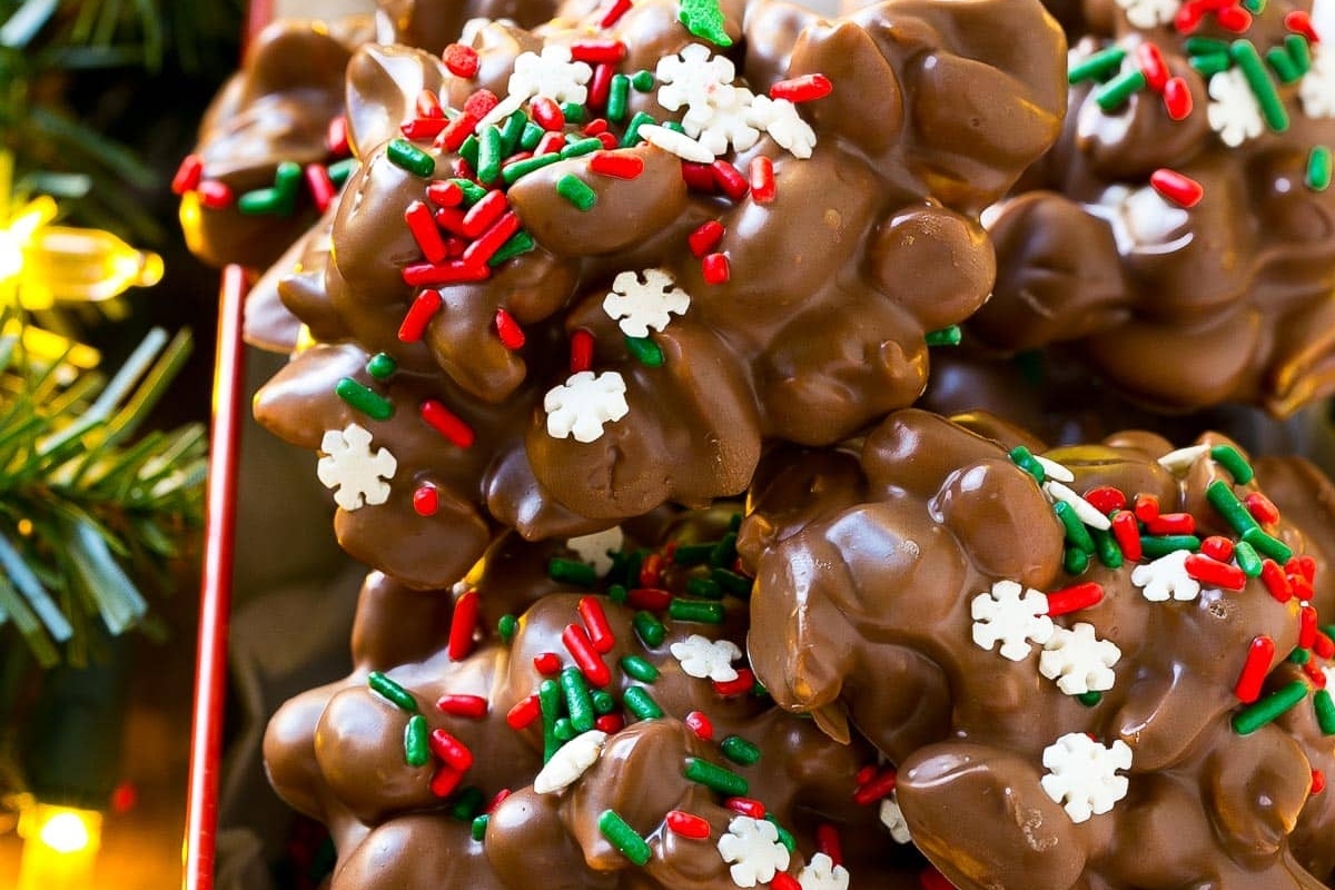 A tray of chocolate covered cookies with Christmas sprinkles, perfect for the holiday season.