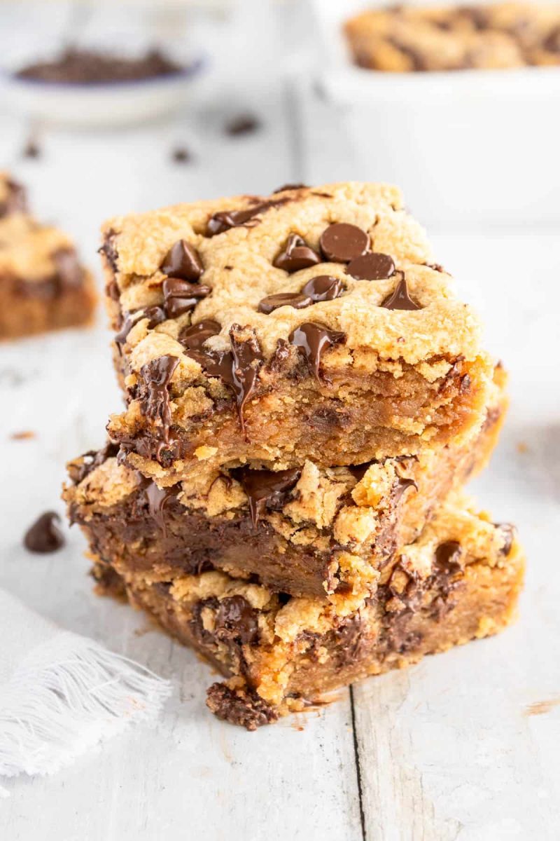 Peanut butter chocolate chip cookie bars stacked on top of each other.