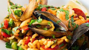 A plate of rice with mussels, clams and prawns, perfect for a feast of the seven fishes.