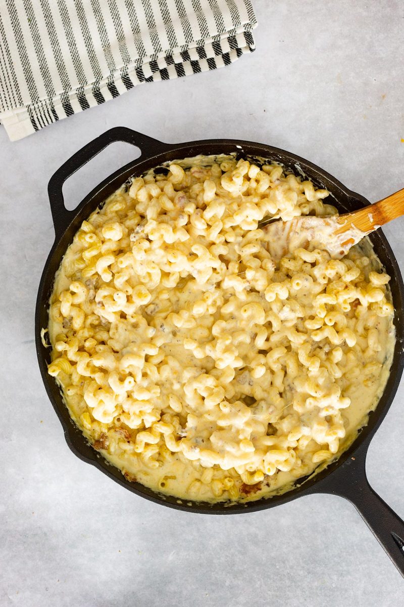 Loaded mac and cheese cooked in a cast iron skillet.