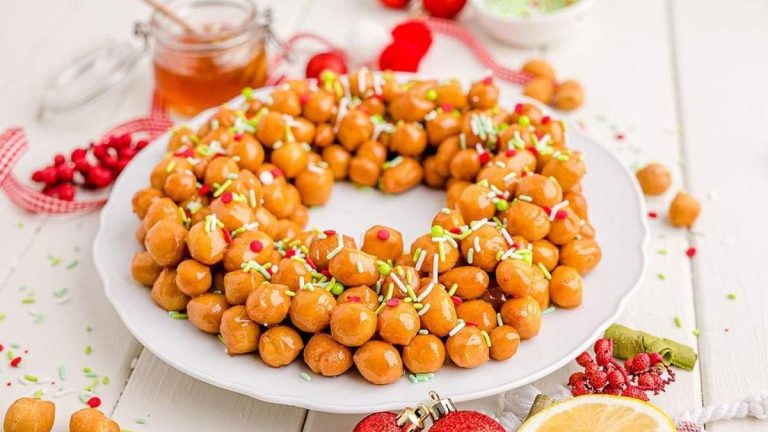 A plate with a wreath of nuts, perfect for holiday cookie recipes.