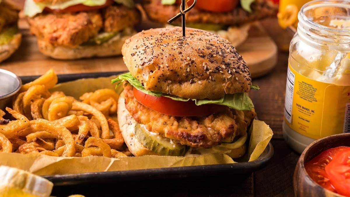 Southern Dinners That Satisfy 6 Chicken burgers with fries and ketchup on a wooden table.