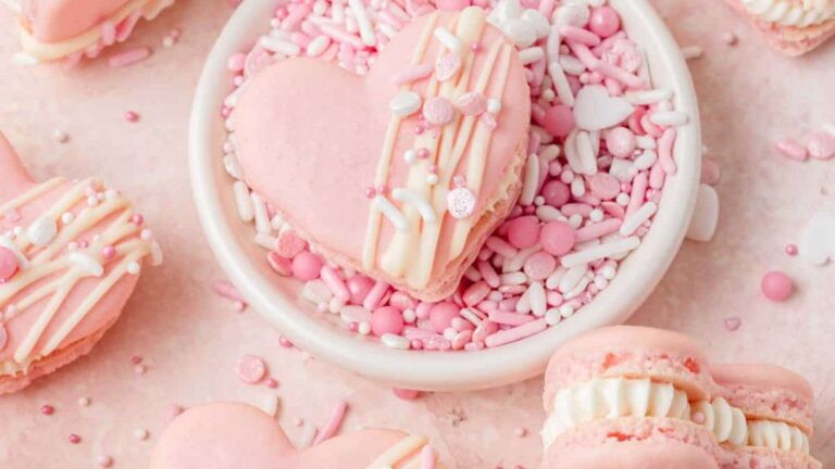 Valentine's Day macarons on a pink background.