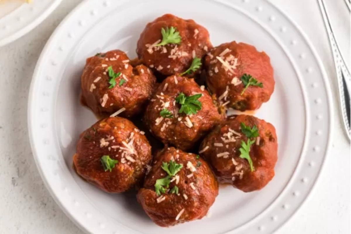 Meatballs on a white plate with parmesan.