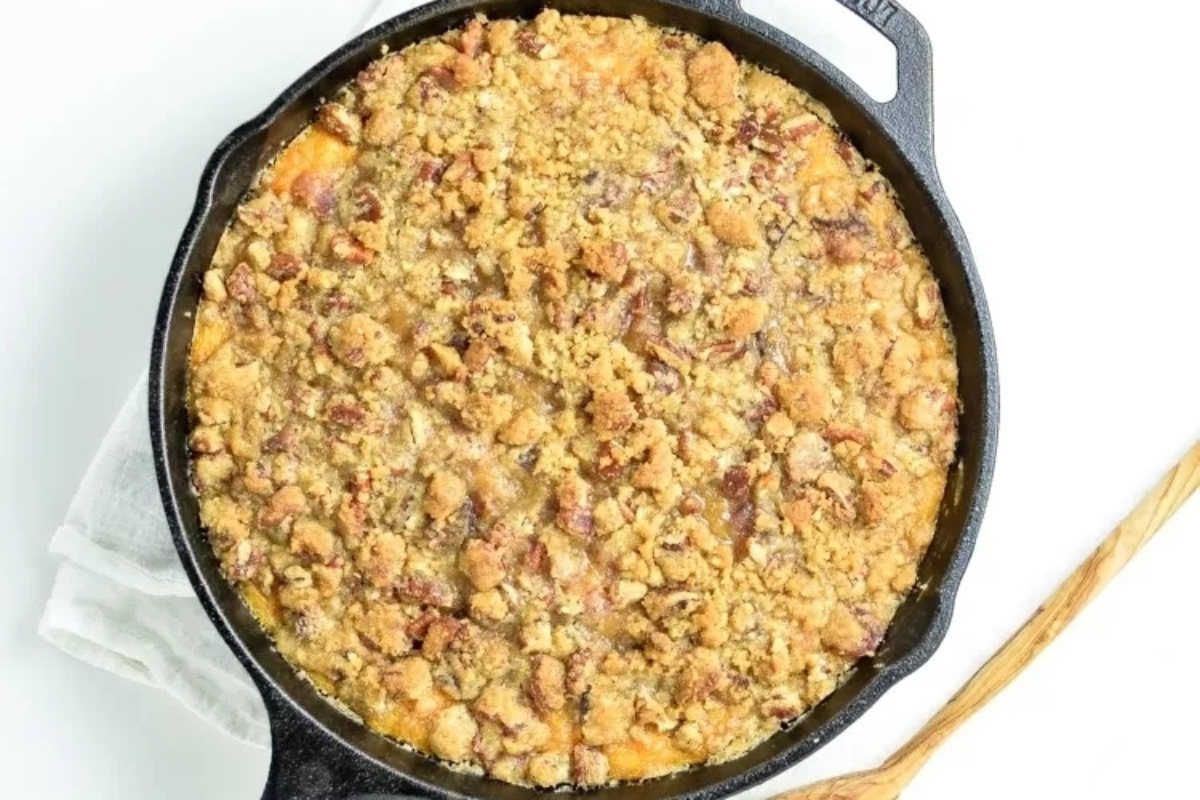 Creative Sweet Potato Recipes 9 Sweet potato casserole in a skillet with a wooden spoon.