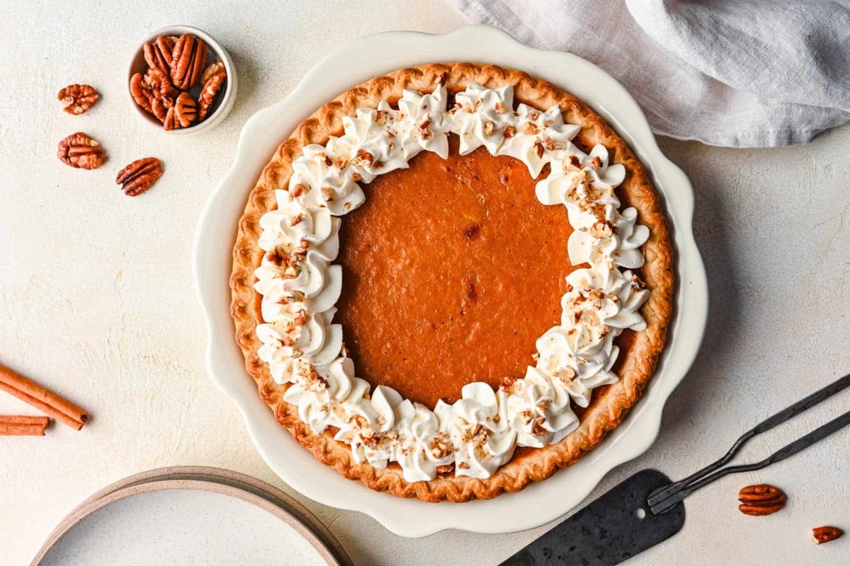 Creative Sweet Potato Recipes 24 A pumpkin pie with whipped cream and pecans.