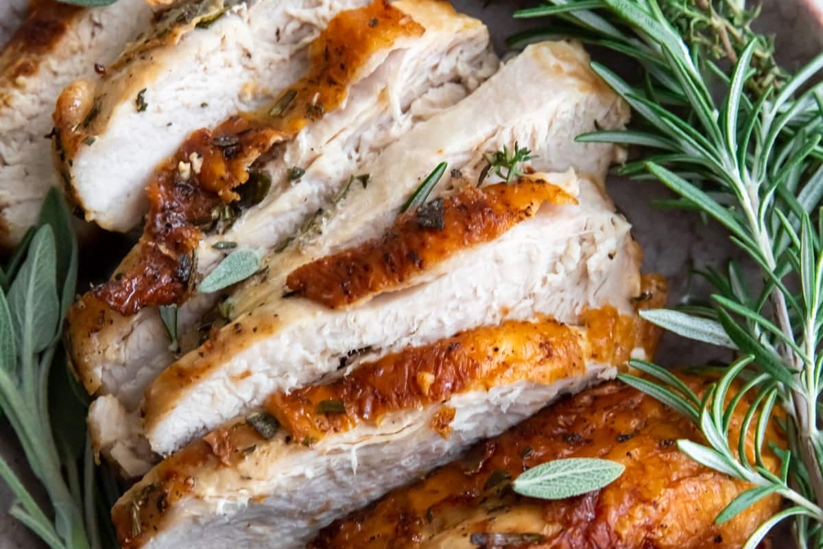 31 Guilt-Free Air Fryer Recipes for Every Meal 28 Sliced turkey with rosemary sprigs on a plate.