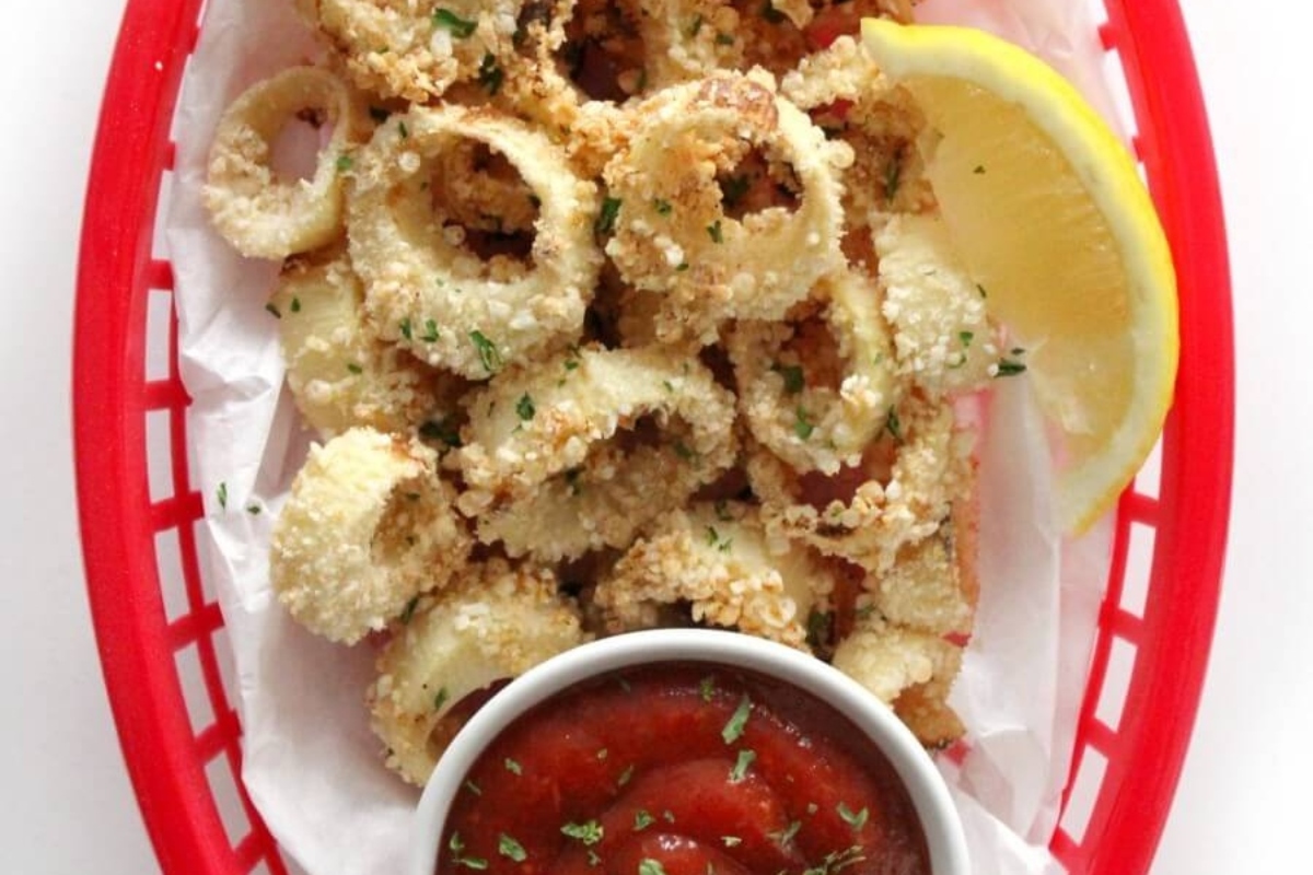 31 Guilt-Free Air Fryer Recipes for Every Meal 26 Fried octopus in a red basket with dipping sauce.