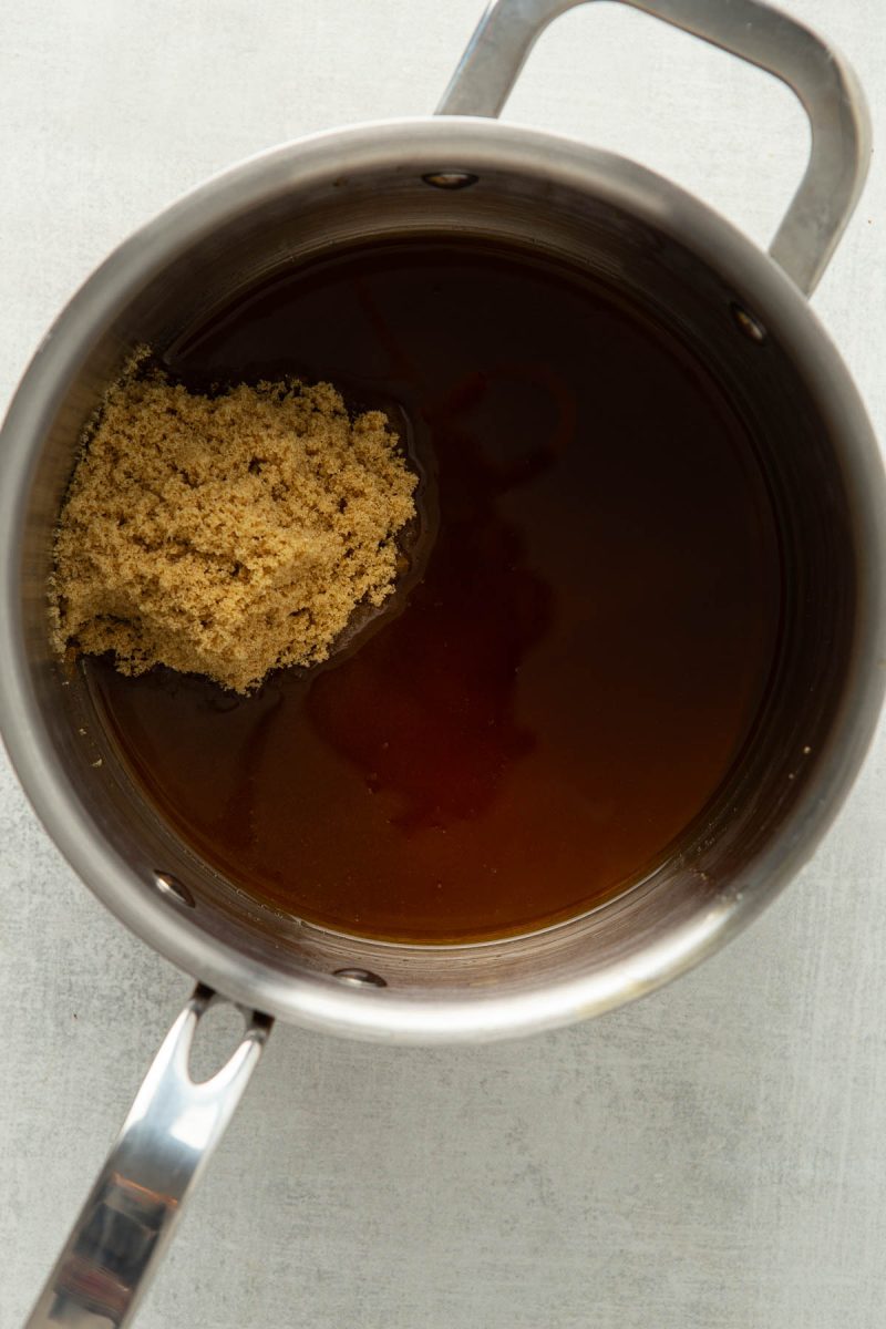 Brown sugar with water in a pot.