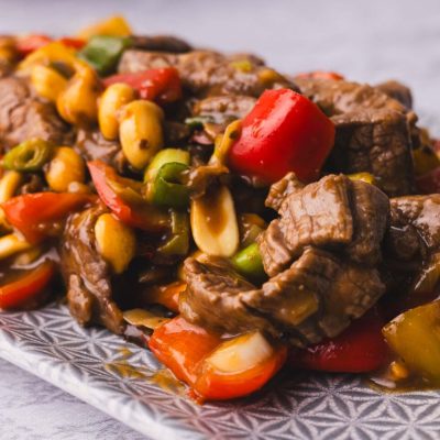 Kung Pao beef stir fry with peppers and onions on a plate.