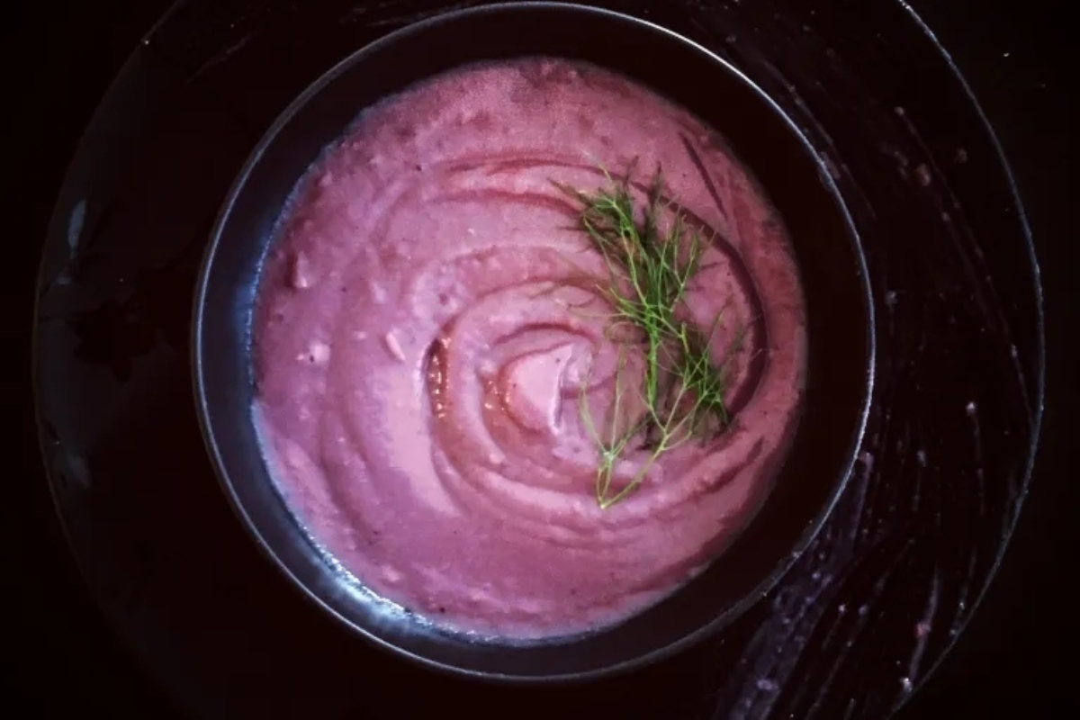 Creative Sweet Potato Recipes 17 A bowl of purple soup with a sprig of dill.