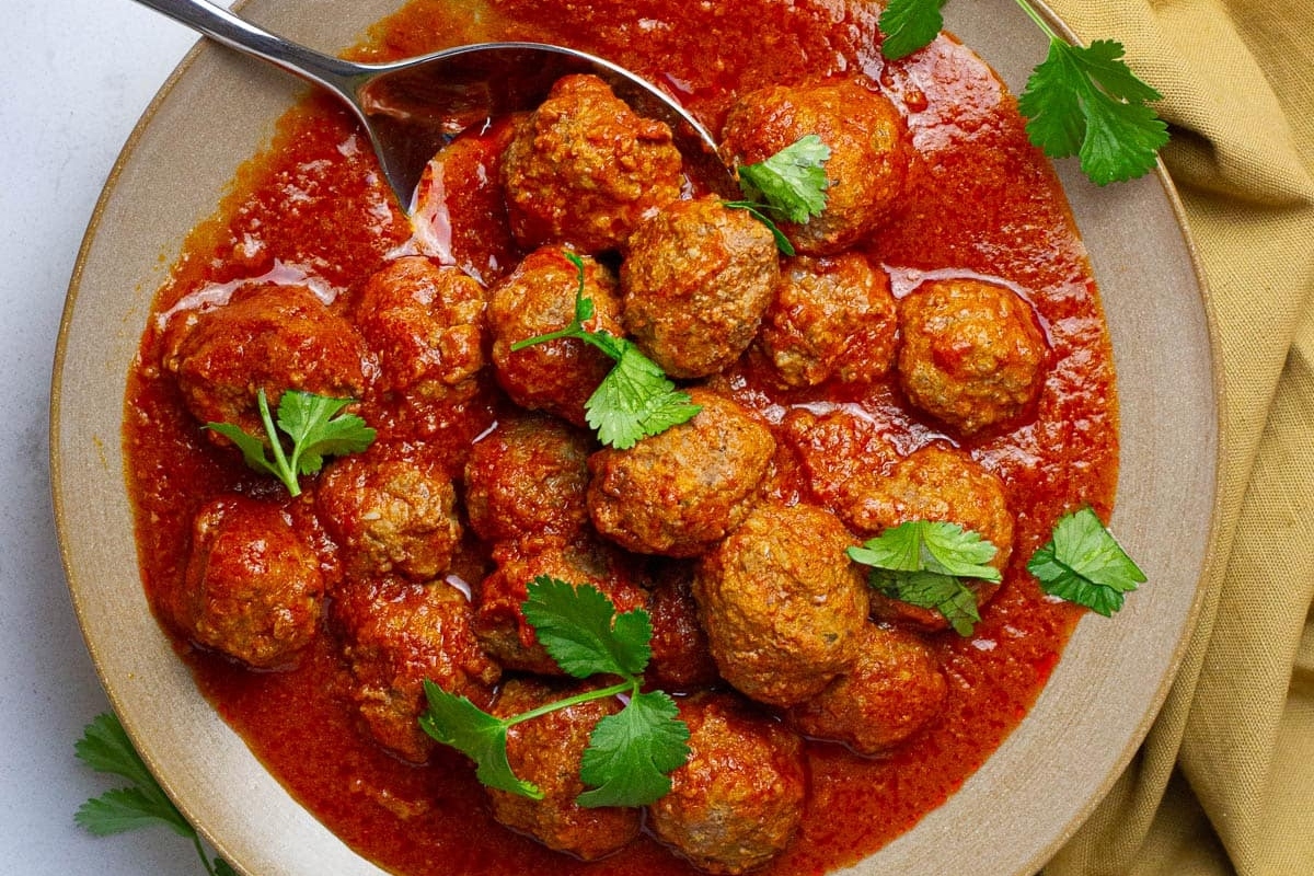 Meatballs in tomato sauce on a plate.