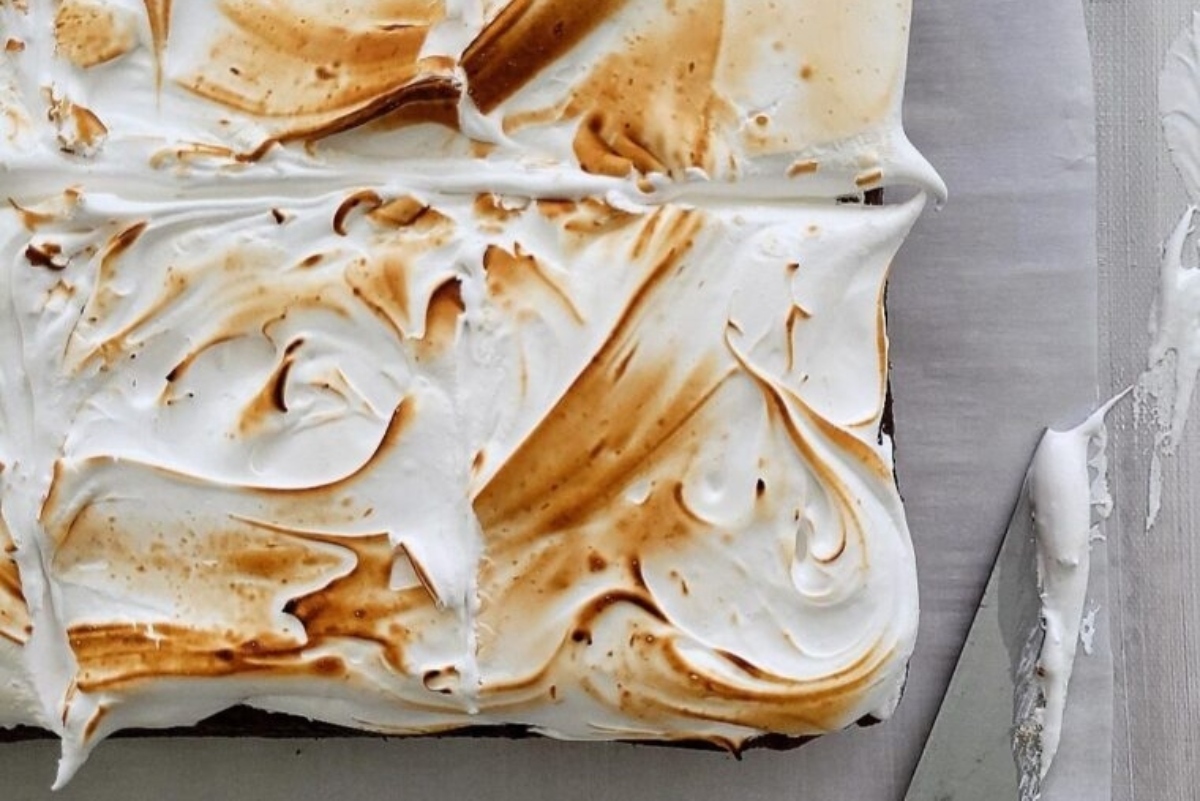 Creative Sweet Potato Recipes 21 A brownie with whipped cream and a knife on top.
