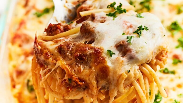 A dish of spaghetti and meatballs in a casserole dish.