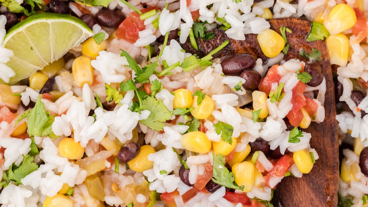 Bowl of rice with corn and other vegetables.