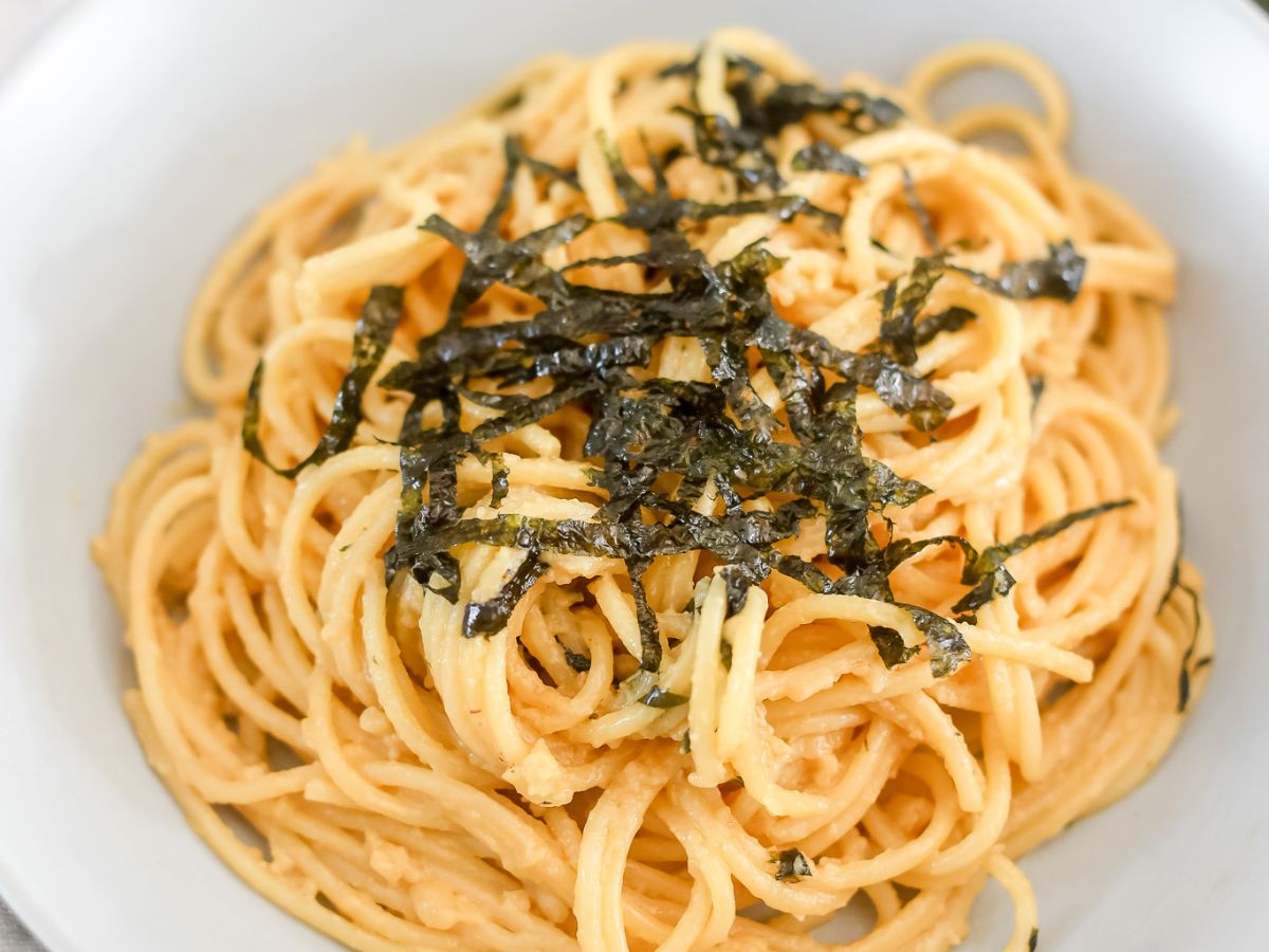 Bowl of miso spaghetti topped with nori.