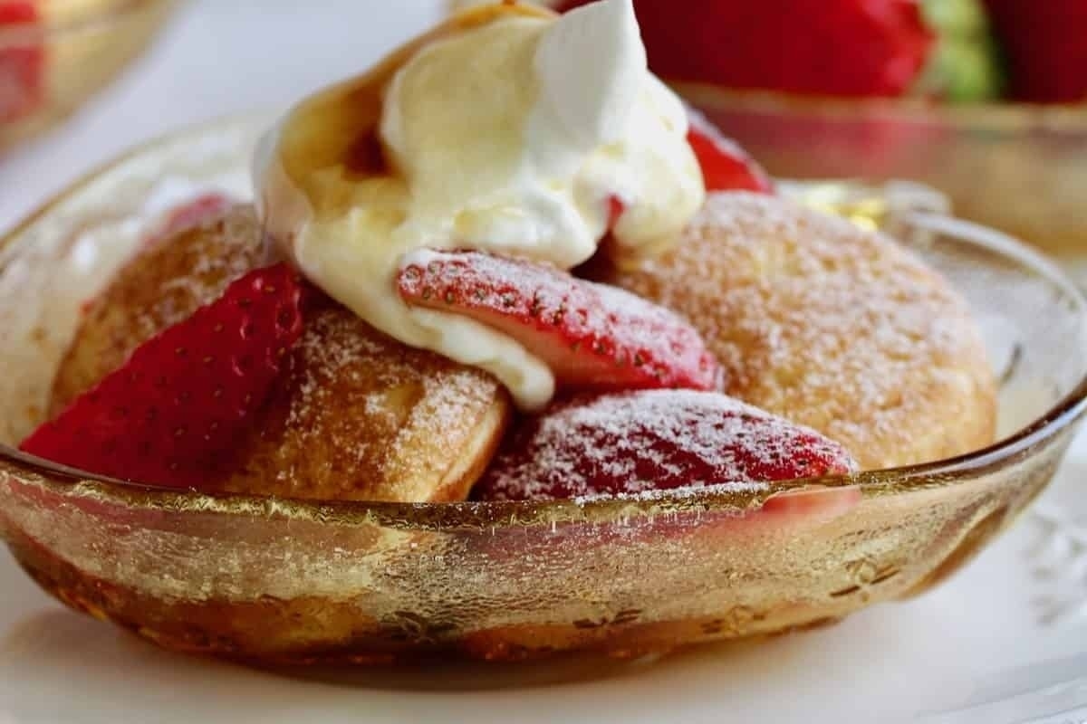 Pancakes with strawberries and whipped cream.