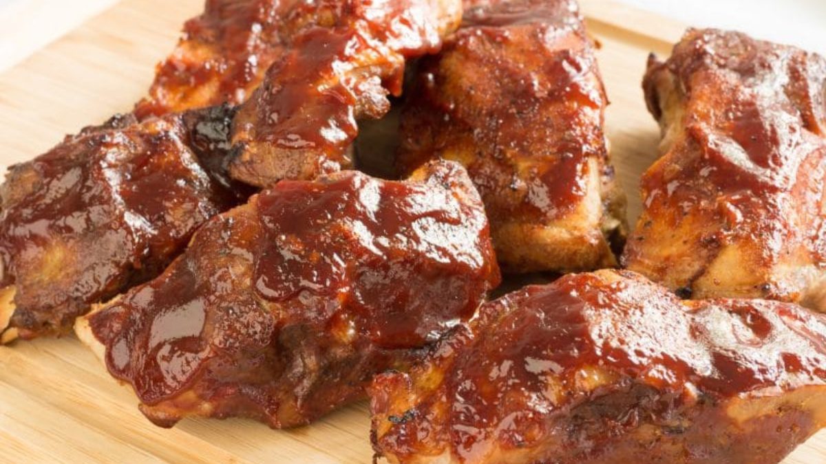BBQ ribs on a wooden cutting board.