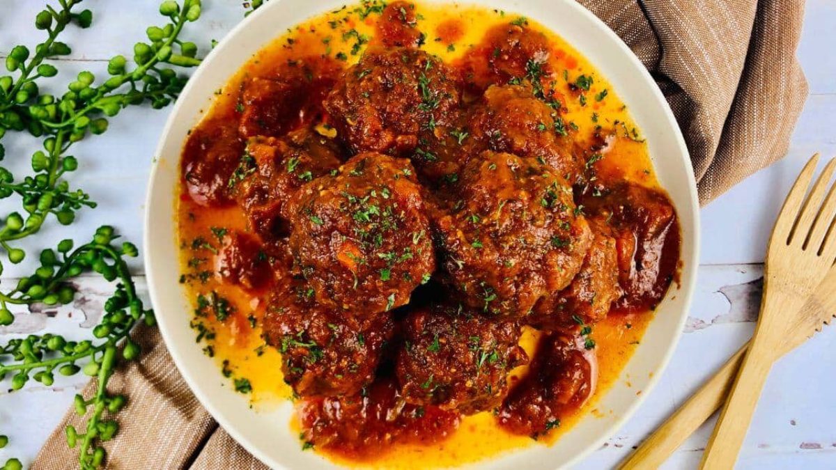 Slow cooked sausage meatballs covered in sauce.